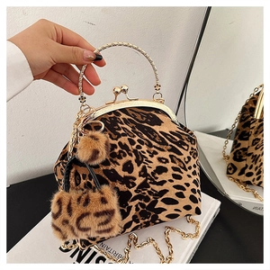 Detail of leopard print shell bag with golden metal handle and chic chain strap