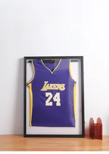 Detail of black jersey display frame showcasing a purple basketball jersey on wall