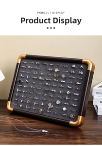 Macro view of walnut wood jewelry display tray with grey velvet slots for rings