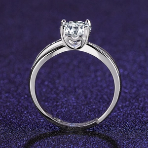 Detail of silver ring showing four-prong setting and hollow heart design on side