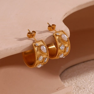 Detail of 18K gold-plated C-shaped earrings with inlaid pearls and sparkling crystals