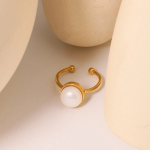 Minimalist adjustable gold ring with a single natural freshwater pearl on white background
