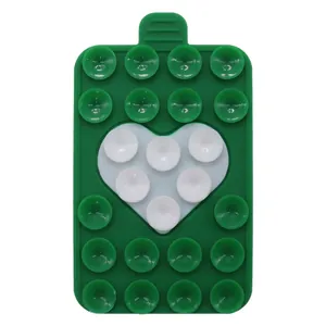 Detail of green silicone suction pad with white heart pattern and 25 vacuum cups