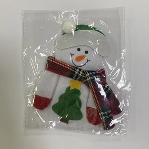 Detailed view of snowman Christmas cutlery holder in felt packaging for holiday tables