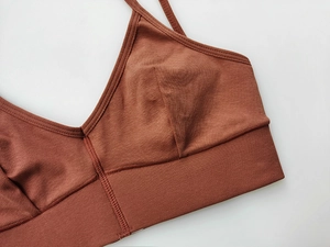 Detailed view of red-brown ribbed knit sports bra with high-quality stitching and fabric