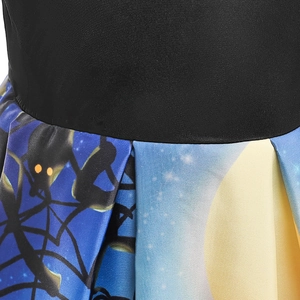 Detail of girls' Halloween dress waist with moon and branch print on polyester fabric