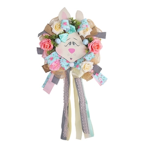 Easter bunny burlap wreath with colorful ribbons, roses, and speckled eggs on white background