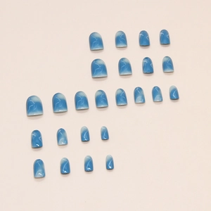 24pcs set of oval blue marble press-on nails with a glossy finish on beige background