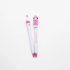 Close-up of nurse pens with cartoon topper and Best Nurse Ever text on white background