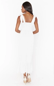 Detail view of the smocked back and adjustable tie-up ribbon straps on the white dress