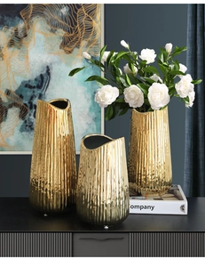 Detail showing gold striped ceramic vase with irregular wavy rim and textured surface