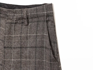 Détail du pantalon écossais en laine avec passants de ceinture et texture des poches