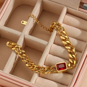 Close-up of 18K gold plated Cuban chain bracelet with a square red zircon in jewelry box