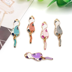 Detailed view of five colorful enamel cat pendants with movable tails for DIY jewelry making
