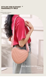 Close-up of heart-shaped quilted shoulder bag in pink with V-pattern stitching detail