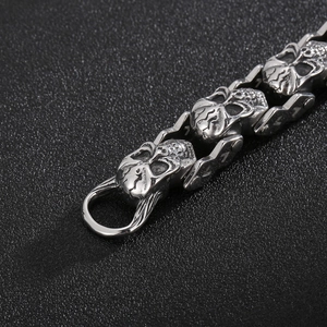 Gros plan détaillé des maillons tête de mort punk sur un bracelet lourd en acier inoxydable