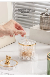 Detail of luxury ribbed organizer jar with gold trim and cute golden bear handle lid