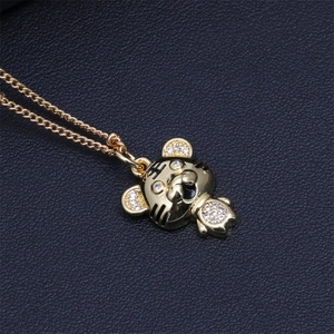 Detailed view of a gold tiger pendant with micro-paved zircons on black leather