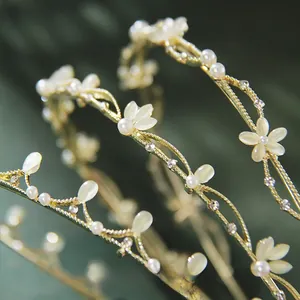 Macro shot of French vintage leaf headband featuring cat-eye stone flowers and white pearls