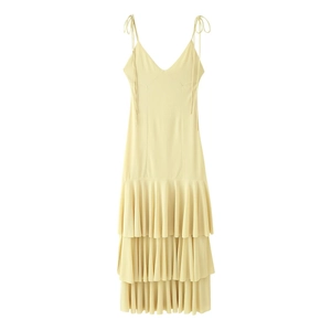 Detail of pale yellow tiered midi dress featuring delicate spaghetti straps and layered ruffle skirt