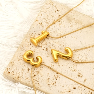 Collier à pendentif chiffre doré minimaliste sur pierre de travertin avec chaîne