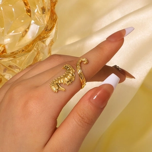 Elegant 18K gold seahorse stainless steel open ring shown on a model with silk background