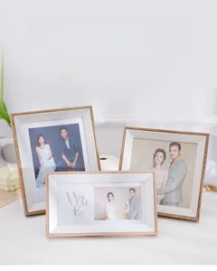 Close-up of Nordic style light wood grain photo frames with white bevel matting for wedding photos