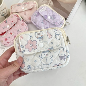 Detail of floral quilted cotton pouch with metal zipper and white snap button closure