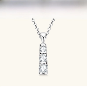 Macro detail of S925 sterling silver necklace with three vertical moissanite stones