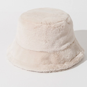 Close-up detail of soft cream-colored faux fur texture on a plush winter bucket hat