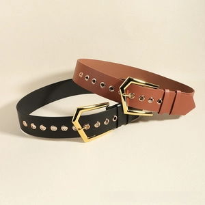 Detail of black and brown elastic waist belts with golden hexagonal buckles and eyelets