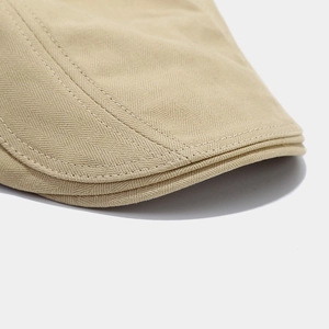 Beige herringbone newsboy cap for men featuring premium retro stitch detailing