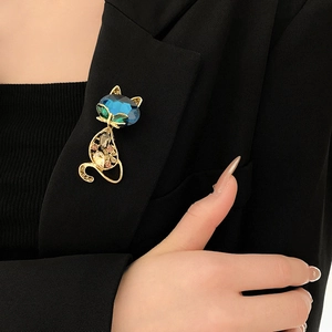 Elegant cat brooch with colorful crystals pinned on a black suit jacket lapel