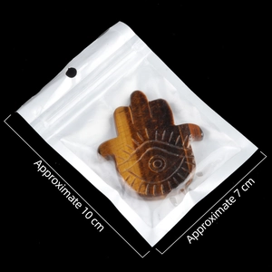 Tiger eye stone Hamsa hand carving ornament measuring approximately 10 cm by 7 cm