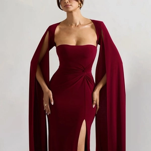 Detail of burgundy evening gown featuring square neck and elegant side slit floor-length hem