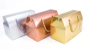 Three elegant gift boxes in silver, rose gold and gold with matching handle ropes