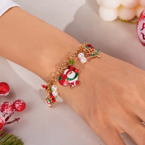 Christmas charm bracelet with Santa Claus and reindeer pendants worn on a festive background