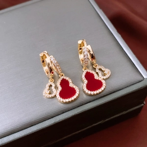 Macro shot of 14K gold plated red double gourd earrings with sparkling zircon inlay