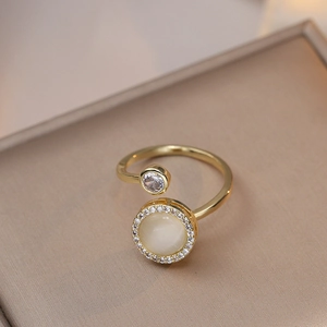 Macro detail of gold-plated ring with cat's eye stone and zircon in a silk jewelry box