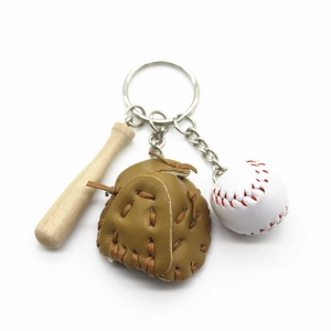Detail of baseball keychain set with leather glove, white ball, and wooden bat