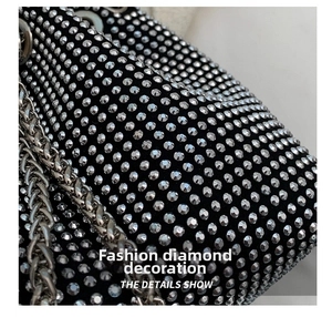 Close-up of sparkling silver rhinestones on black velvet fabric with silver chain detail