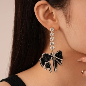 Gothic style crystal bow earrings with silver needles and hanging black rhinestones