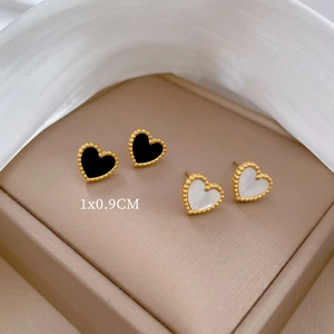 Minimalist titanium heart earrings in black and white shell set on beige leather box
