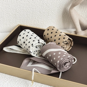 Set of three French polka dot and geometric silk scarves displayed on a brown tray