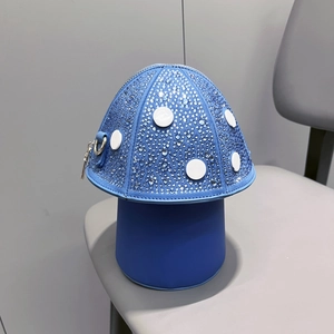 Detail of mushroom-shaped blue handbag featuring sparkling rhinestones and white dots