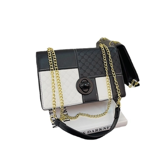 Fashionable black and white contrast leather crossbody bag with chain and rhombic pattern