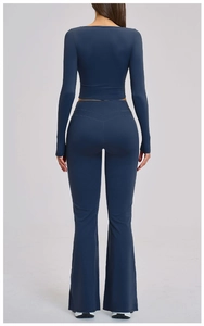 Back view of yoga set featuring high-waisted flared pants and a long-sleeve crop top