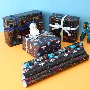 Video game gift wrapping paper featuring gamepads and pixel icons on black background