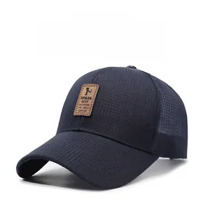 Close-up of breathable waffle texture and brown leather patch on navy baseball cap