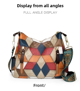 Detailed front view of multi-color patchwork leather tote with decorative gold zippers